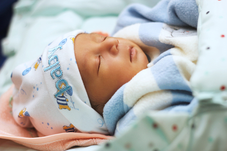 New born Baby sleeping in the bedの写真素材