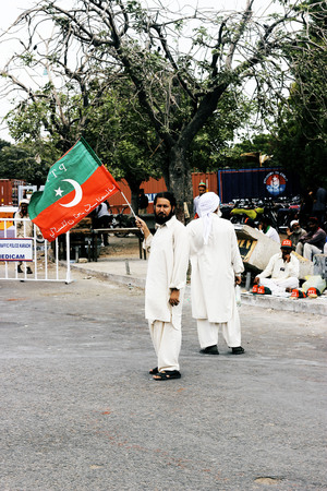 KARACHI, PAKISTAN - 21/09/2014 Tehreek-e-Insaf (PTI) Chairman, Imran Khan addresses to public meeting Mazar-e-quaid, Karachi .Supporter holding flagのeditorial素材