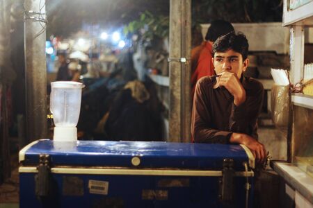 Child Labour - Boy working at milk shake shop at Bahadurabad, Karachi, Pakistan 13/03/2013のeditorial素材