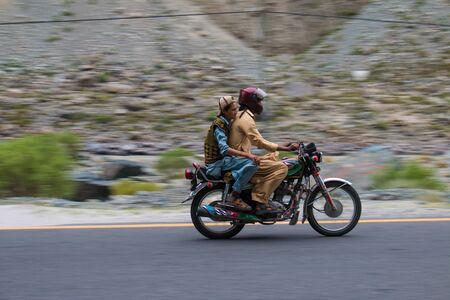 Men Riding on Bike in the Mountains, One Wearing Helmit, In Hunza Pakistan 29/06/2018のeditorial素材