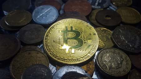Bitcoin. Physical bit coin. Digital currency. Cryptocurrency. Golden coin with bitcoin symbol. Stock...