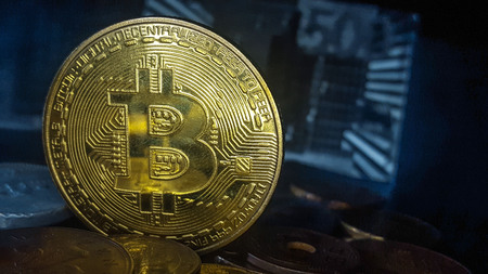 Bitcoin. Physical bit coin. Digital currency. Cryptocurrency. Golden coin with bitcoin symbol. Stock...