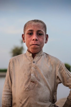 Portrait Of A Village Boy, Standing And Looking At Camera In Sindh, Moro, Pakistan 26/08/2017のeditorial素材