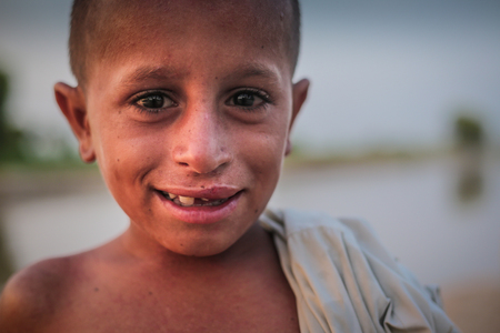 Portrait Of A Village Boy, Smiling And Looking At Camera In Sindh, Moro, Pakistan 26/08/2017のeditorial素材