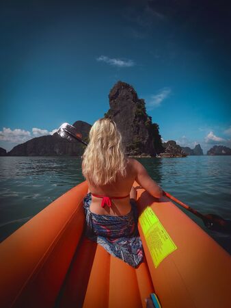 Blond Girl Kayaking Toward A Beautiful Rocky Island In Phuket, Thailnad 19/11/2019のeditorial素材