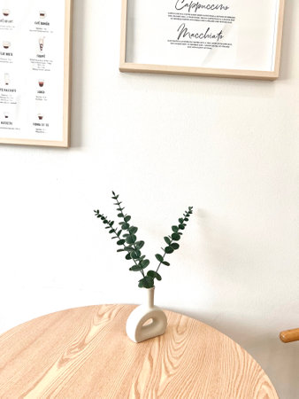 Eucalyptus plant in a vase on a wooden tableの写真素材