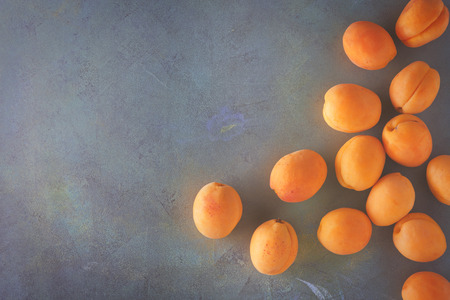 Fresh ripe apricots scattered on the table. Top view with copy space.の写真素材
