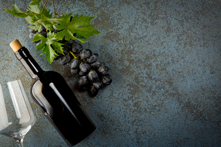 Fresh ripe juicy grapes, bottle of red wine and space for text on top viewの写真素材