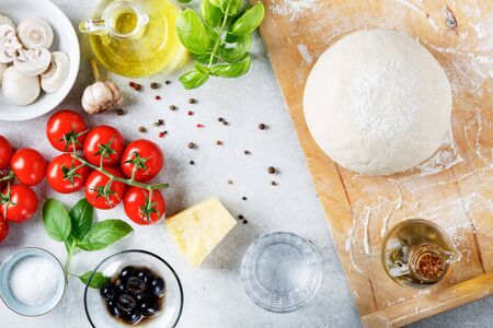 The ingredients for homemade pizza on wooden background. Top view.の写真素材