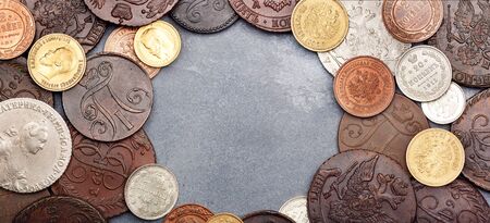 Numismatics. Old collectible coins made of silver, gold and copper on a table. Top view. Copy space of your text. Banner.の写真素材