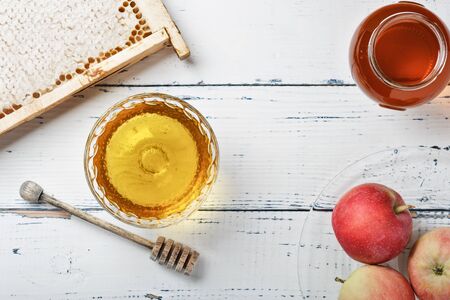 Honey background. Sweet honey in the comb, glass jar. On wooden background. Top view.の写真素材