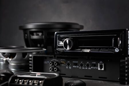 car audio, car speakers, subwoofer and accessories for tuning. Dark background.