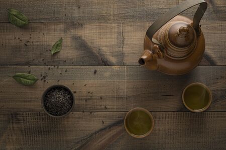Tea concept. Teapot with tea on table. View from above with copy space. Asian tea bowl and teapot.の写真素材