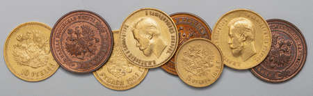 Numismatics. Old collectible coins made of silver, gold and copper on a wooden table. Top view.の写真素材