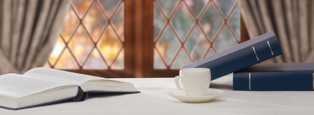 stack book and cup of coffee on wooden tableの写真素材