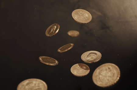 Numismatics. Old collectible coins made of gold. Dark background.