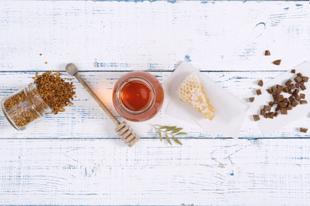 Honey background. Beekeeping products honey, pollen, propolis, honeycomb on a wooden table. Copy space of your text.の写真素材