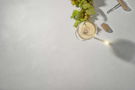 Glass of white wine on vintage wooden table. Top view.
