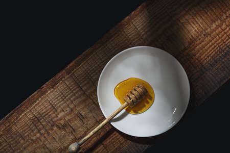Honey background. Sweet honey and a spoon for honey on the table. Top view ..の写真素材