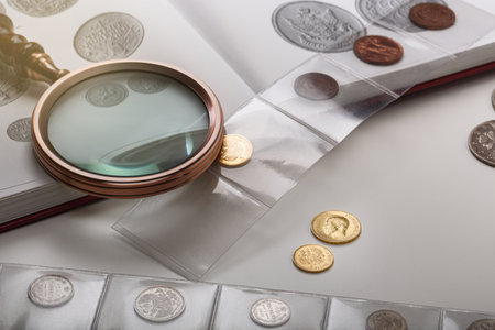 Numismatics. Old collectible coins on a table. light background.の写真素材