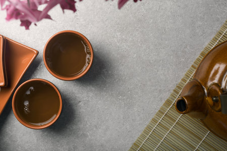 Asian tea concept, two cups of tea and a teapot. top view.の写真素材