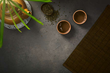 Asian tea concept, two cups of tea and a teapot. top view.の写真素材