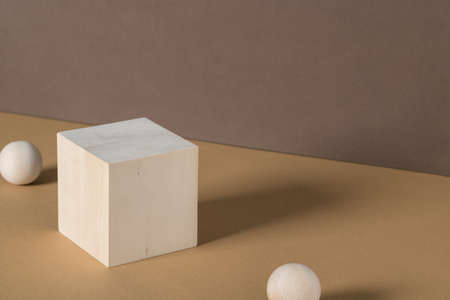 Square wooden saw on brown background abstract background. Minimal box and geometric podium. Scene with geometric shapes. Empty showcase for eco cosmetic product presentationの写真素材