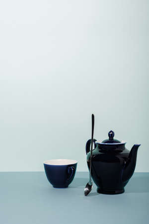 Teacup and teapot on the table. light background.の写真素材