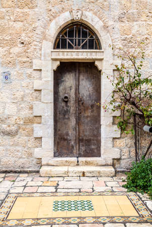 Old iron double door with half round transom on one of the streets of Jerusalem, Israelのeditorial素材