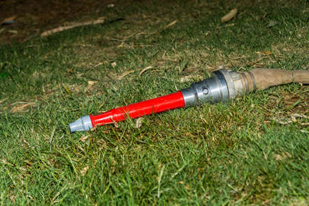 Fire hose on the grass, fire fighting equipmentの写真素材