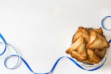 Hamantaschen or Haman's ears - triangular cookies for Jewish holiday of Purim, on light backgroundの写真素材