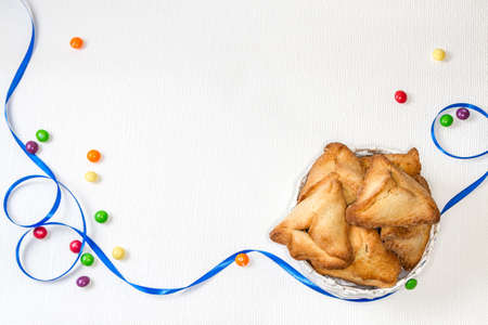 Hamantaschen or Haman's ears - triangular cookies for Jewish holiday of Purim, on light backgroundの写真素材