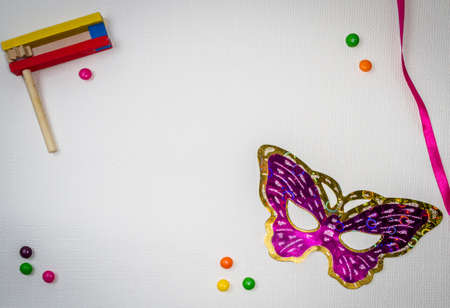 Jewish holiday of Purim, carnival mask and wooden gragger, free space for textの写真素材