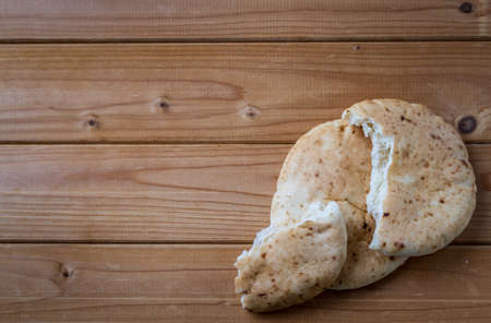 Pita, Arabic bread, soft baked flatbreads on wooden background with free space for textの写真素材