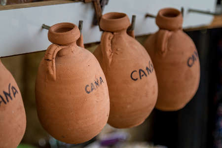 The pottery jugs, small souvenirs imitating ancient wine jugs in the gift shop in Cana of Galilee, Israel. Selective focusの写真素材
