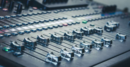 The audio equipment, control panel of digital studio mixer, side view. Close-up, selected focus