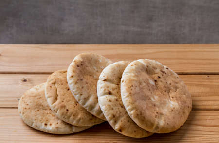 Pita, Arabic bread, soft baked flatbreads on wooden backgroundの写真素材