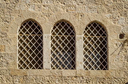 Exterior of the Dormition Abbey, arched barred windows of catholic church, in Jerusalem, Israel.の写真素材