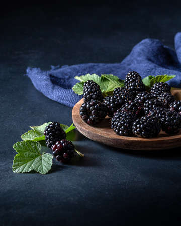 blackberries on a blue table.の写真素材