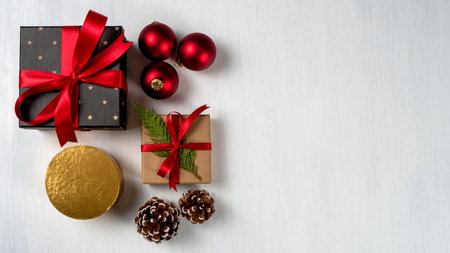 Christmas composition. Christmas presents, pine cones, red Christmas balls on a white background. Top view, copy space ..の写真素材