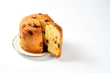 Classic panettone with dried fruits, traditional Italian Christmas cake on white background. Before the piece, a piece of cake., front view, isolated.の写真素材