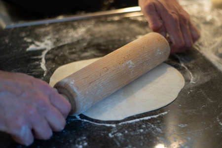 man making Tex-Mex food such as burritos, enchiladas, tacos etc. Close-up, selected focus, blurry.の写真素材