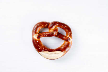 Appetizing Bavarian pretzel isolated on a white background. Top view, copy space, isolated.の写真素材