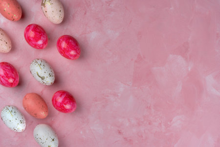 Colored easter eggs on a pink background, top view, copy space.の写真素材