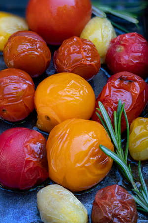 Red, yellow and white tomatoes grilled with olive oil, rosemary, salt and pepper.の写真素材