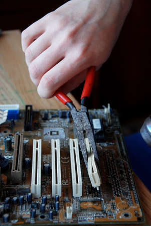 Cropped Hand Of Person Working On Circuit Board
