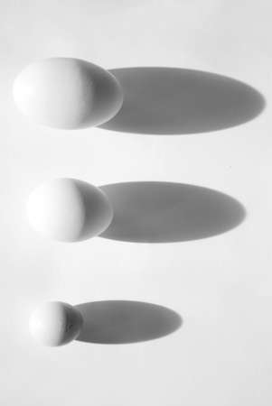 Three eggs of different sizesの写真素材
