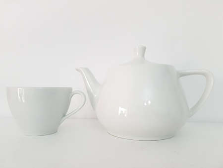 White tea cup and tea pot on white backgroundの写真素材