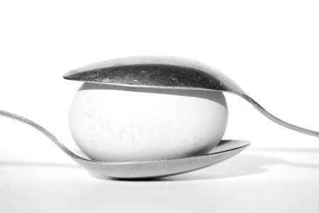 Egg between two spoons