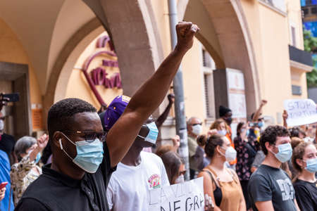 Palma de Mallorca, Spain - June 07 2020: Man surrounded by crowd raising the fist in a peaceful protest against racism and recent US police brutalityのeditorial素材